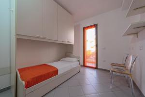 Posteľ alebo postele v izbe v ubytovaní Isola Che Non C'é Trilocale Casa Vacanze 80 mq con Terrazza La Maddalena Sardegna