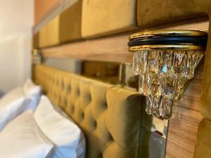 a chandelier hanging from a wall in a room at Vila Imperial One Luxury Boutique Hotel in Făgăraş