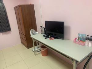 a desk with a computer monitor on top of it at Fangliao Homestay in Fangliao