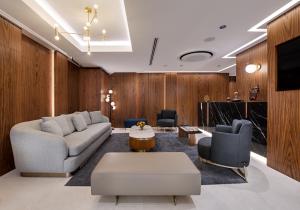 a living room with a couch and two chairs at Gleam Collection Hotel in Istanbul