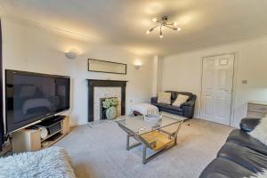 a living room with a large flat screen tv at Guest Homes - Lion Court in Worcester