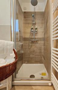 a shower with a glass door in a bathroom at Il Cortiletto - Suites & Apartments in Pistoia