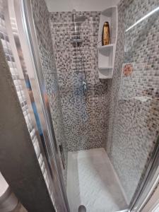 una doccia con porta in vetro in bagno di Casa Emilia a Ragusa
