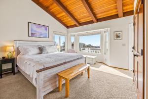 a bedroom with a bed and a wooden ceiling at All Decked Out in Cambria in Cambria