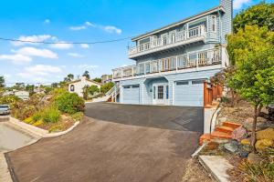 a driveway leading to a house with a balcony at All Decked Out in Cambria in Cambria