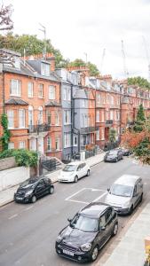 a group of cars parked on a city street at The Avonmore Olympia in London
