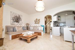 a living room with a couch and a table at Luxury house in Cannigione in Cannigione