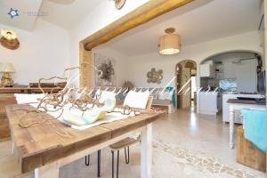 a living area with a wooden table and a dining room at Luxury house in Cannigione in Cannigione