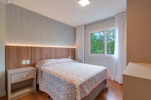 a small bedroom with a bed and a window at Atalaia - Stay House Temporada in Canela