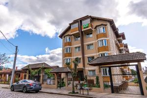 a building with a car parked in front of it at Atalaia - Stay House Temporada in Canela