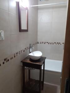 a bathroom with a sink and a bath tub at Ayres Apart in Chivilcoy