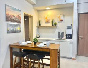 a kitchen with a wooden table and two chairs at Imperium Residence Kuantan Level 12 in Kuantan