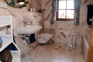 a bathroom with a sink and a toilet at Ferienwohnung Goller in Lenggries