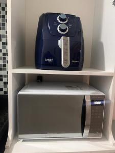 a toaster oven sitting on top of a microwave at Wintervilleflat904 in Gravatá +41 photos