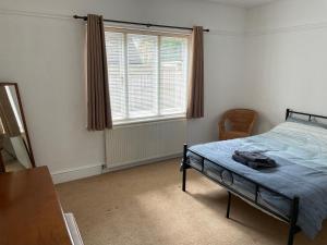 a bedroom with a bed and a window at Green Bank in Hereford