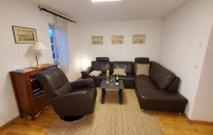 a living room with a couch and chairs and a table at Die alte Kantorei - historische Ferienwohnung in Kahla