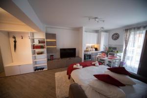 a bedroom with a large bed with red pillows at Alezi Residence in Braşov