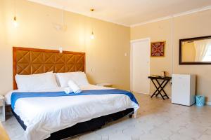 מיטה או מיטות בחדר ב-Nkosazana Guest House