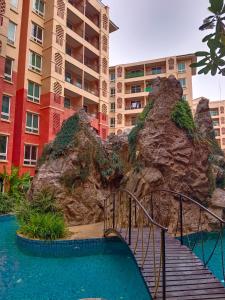 a staircase leading to a resort with a rock formation at Seven Seas Condo Resort Beautiful Location in Jomtien Beach