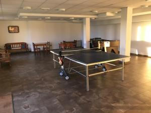 a ping pong table in the middle of a room at Apartamentos Monterodiles in Liñero