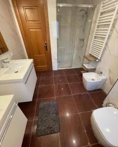 a bathroom with a sink and a toilet and a shower at La Casona El Carrascal in La Gandara
