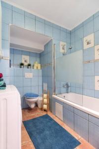 a bathroom with a tub and a toilet and a sink at Spacious central apartment in Vienna