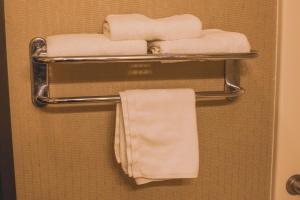 a towel rack with towels on it in a bathroom at Colfax Inn By Marifah in Colfax
