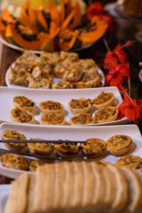 a table with three trays of food on plates at Pousada Pura vida in Itacaré +160 photos