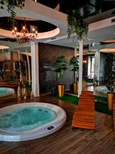 a jacuzzi tub in the middle of a room at Aviator in Pabianice