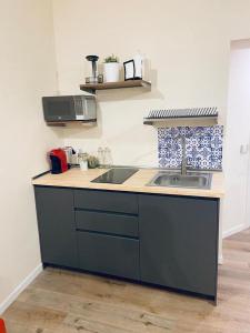 a kitchen with a sink and a counter top at Casa Nina in Rome