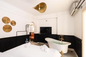 a bathroom with a tub and a tv at The Bold Signature 1BDR Studio Cairo's Downtown in Cairo +15 photos