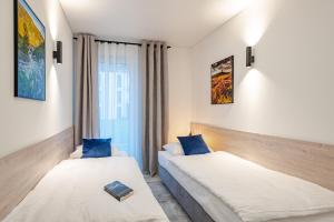 een hotelkamer met 2 bedden en een raam bij Apartament Blue Moon in Jelenia Góra