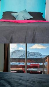 a bed with a view of the mountains from a window at Orcières Rond Point des Pistes 1 Panoramique, Front de Neige in Orcières