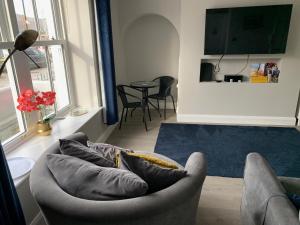 a living room with a couch and a table at Seaview Aurora House - Central Luxury Apartment in Warrenpoint