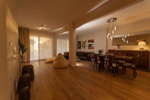 a living room and dining room with a dining table at Harmony Sea View Apartment in Thessaloniki