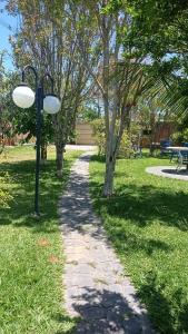 a path in a park with a light pole at Estúdio dentro de uma chácara em Botucatu rubiao jr in Botucatu