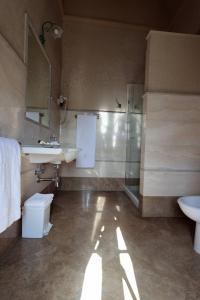 a bathroom with a sink and a toilet and a shower at Hotel Corte dei Tini in Teramo