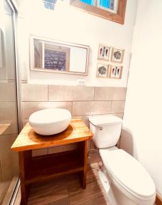 a bathroom with a white sink and a toilet at Casa Le Parc - Main Street in Bocas del Toro