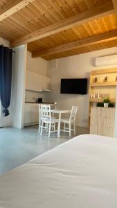 a bedroom with a bed and a table and chairs at Olea b&b in Montecosaro