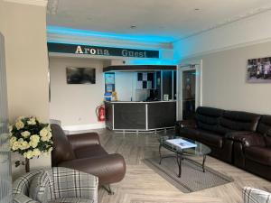 a living room with a couch and a table at Arona Guest Hotel in Great Yarmouth