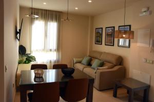 a living room with a table and a couch at APTOS MILLÁN in Ardales