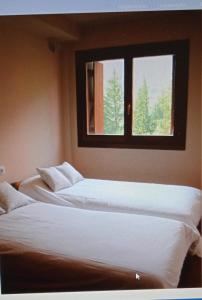 A bed or beds in a room at Apartamentos Nevados 28311