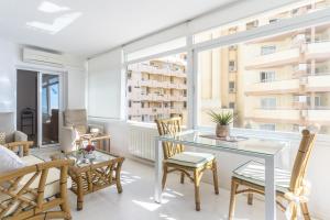 a living room with a table and chairs at Deluxe Apartment on the First Line in Marbella