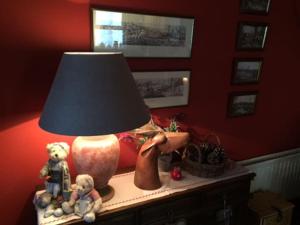 a lamp sitting on top of a table with stuffed animals at Primrose Cottage, Bushmills - Cosy Self Catering Property in Bushmills