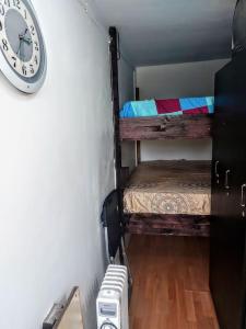 a room with two bunk beds and a clock on the wall at Front Garden Cabin Home with Terrace(Self Check-in) 