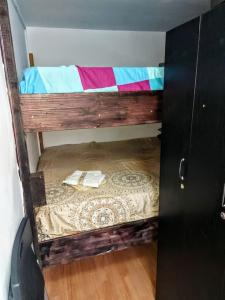 a bunk bed in a room with a wooden floor at Front Garden Cabin Home with Terrace(Self Check-in) 