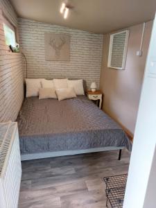 a bedroom with a bed in a small room at Hi-Bp Garden City Batsanyi Tiny House near the city train with FREE PARKING in Budapest