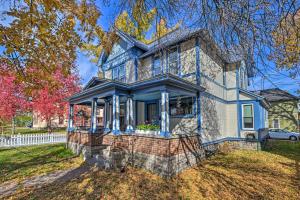 una casa azul con una valla blanca en Victorian Apartment Less Than 1 Mi to Wisconsin River, en Stevens Point