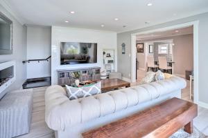 a living room with a white couch and a table at Luxe Laguna Home with Ocean View Walk to Beach in Laguna Beach