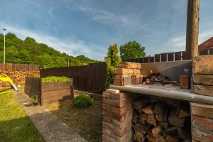 a backyard with a stone fireplace in a yard at LTE Apartments in Maribor